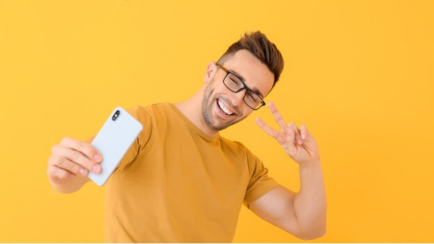 a man in yellow taking a picture of himself