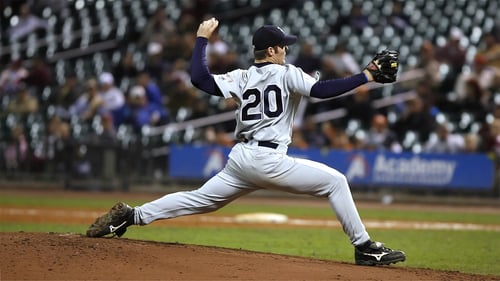 Blog Post Thumbnail: a yankees pitcher throwing a pitch