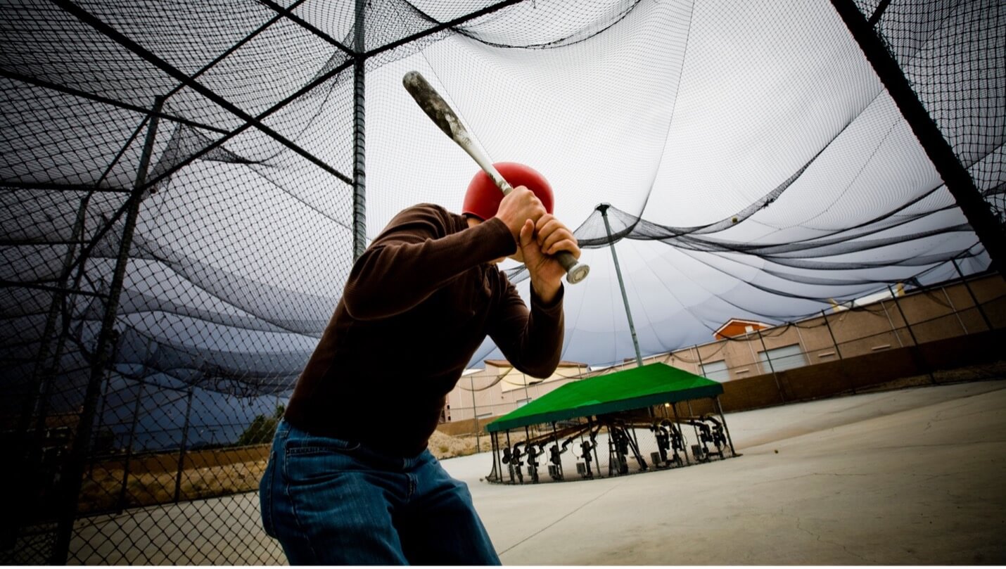 a guy in a batting cage
